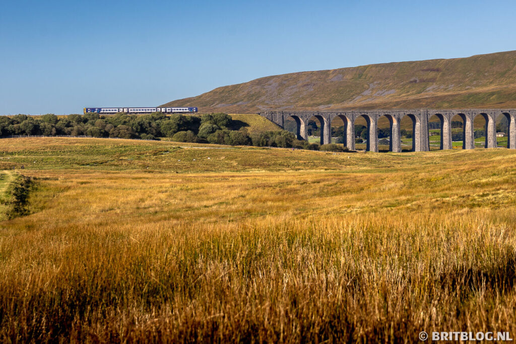 Een trein rijdt over Ribblehead Viaduct, North Yorkshire, Engeland.
